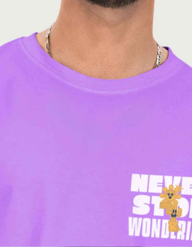 Back view of oversized t-shirt highlighting large "Never Stop Wondering" text with golden cactus design and superior print quality